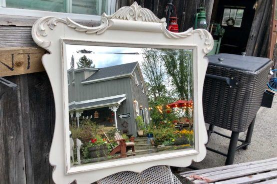 white antique mirror with ornamental border