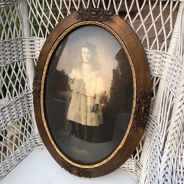antique photo frame with a photo of a woman in white dress