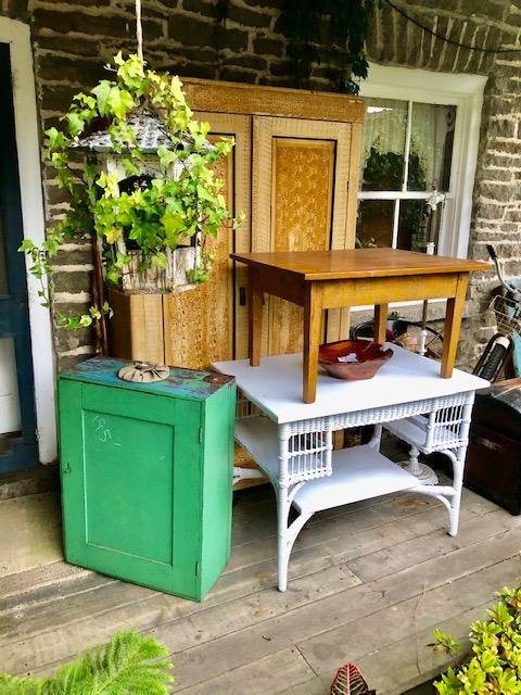 brown wooden table on top of a white table with large wooden cabinet at the back