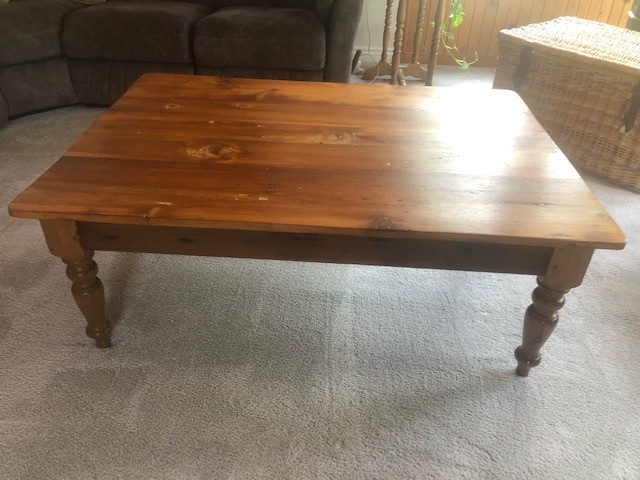 plain wooden table on a carpeted floor