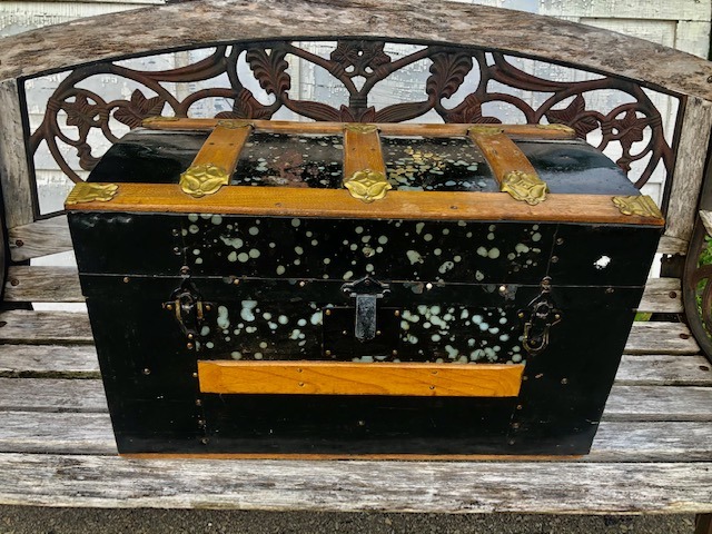 black wooden box on top of a wooden bench