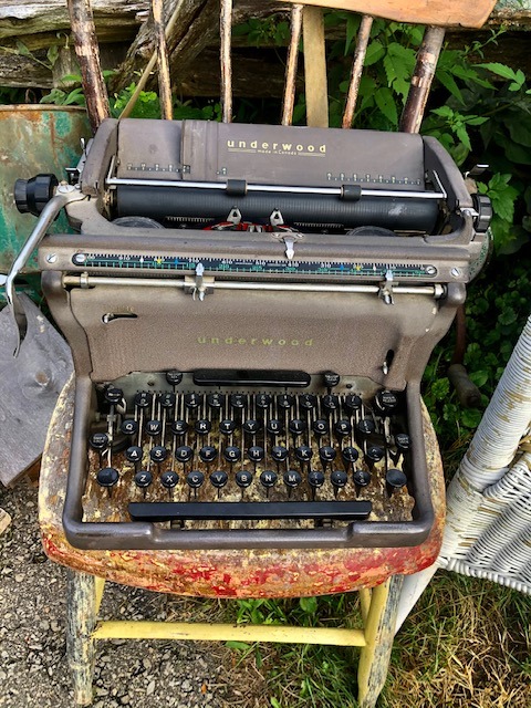 old typewriter on top of an old chair
