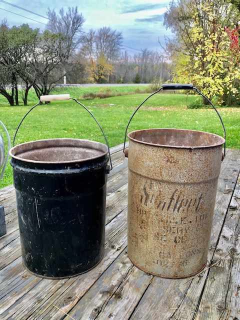 two old metal paint buckets
