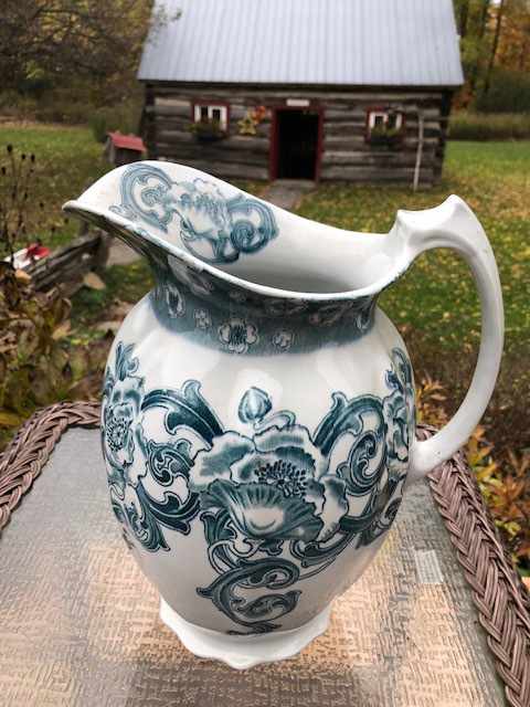a china water jug with a floral decoration
