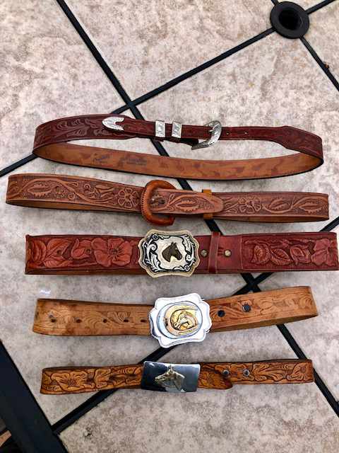 assortment of five hand made belts and buckles