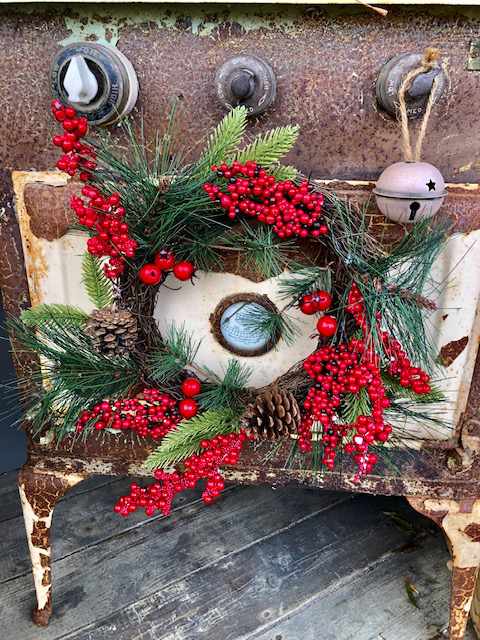 old rusted washing machine covered in festive decorations