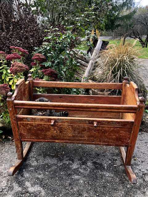 wooden child's cradle on rockers