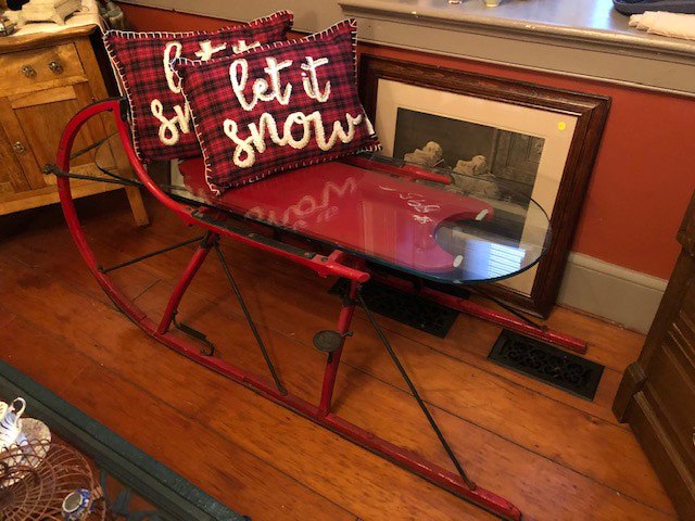 glass coffee table in the shape of a sleigh