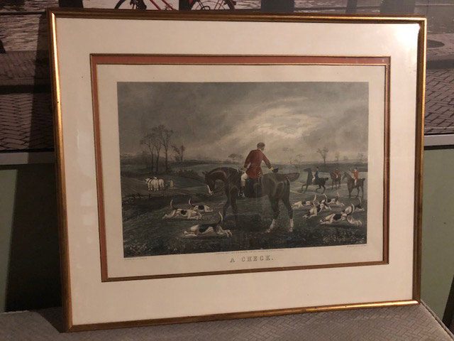 framed picture of a mounted man checking his hunting dogs