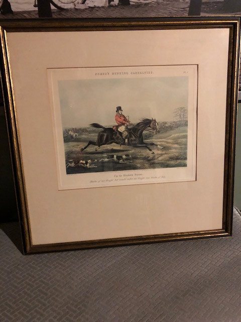 framed image of a man on horseback leaping a stream