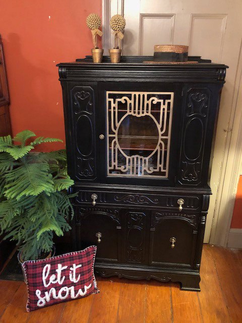 black wooden display cabinet with gold trim