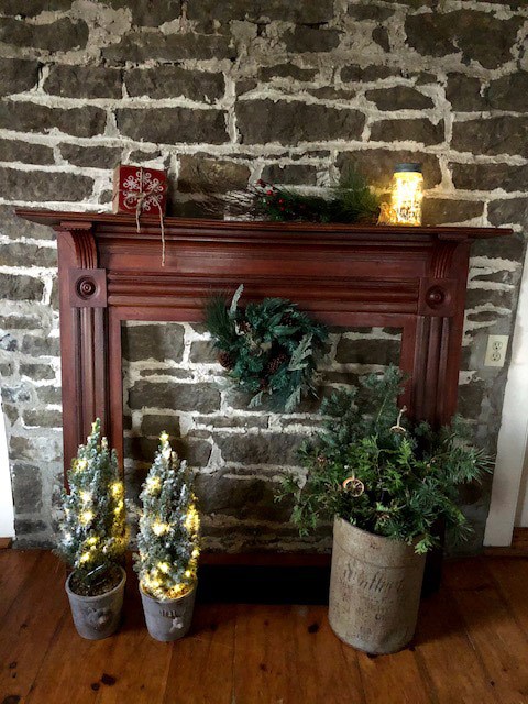 wooden fireplace mantle with festive decorations