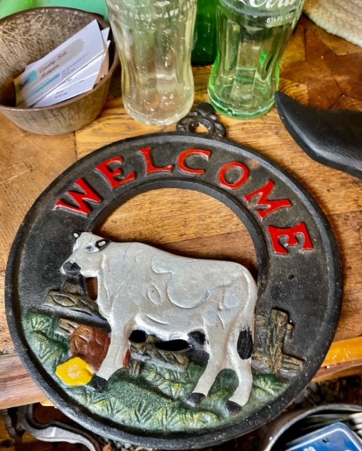 welcome door or wall ornament featuring a cow