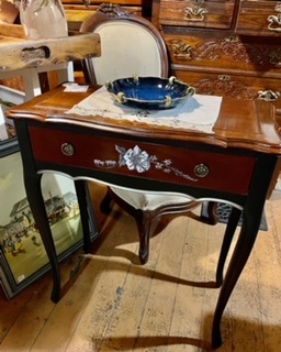 ornate table in front of a chair