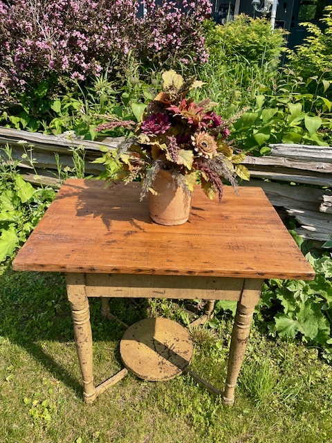 Flower pot kept above wooden table