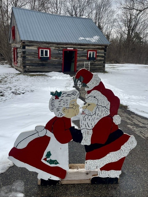 Painted wooden cutout of Santa and Mrs. Claus